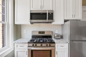 a kitchen with a stove and a microwave at Bright Brighton 1BR near T Shops BOS-775 in Boston
