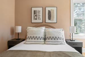 a bedroom with a bed with two lamps and two pillows at Bright Brighton 1BR near T Shops BOS-775 in Boston