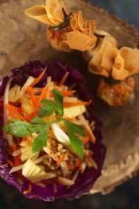 a plate of food with a salad and vegetables at Sanak Retreat Bali in Munduk