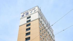 a tall building with a clock on top of it at Toyoko Inn Gumma Ota eki Minami guchi in Ota