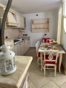 uma cozinha com uma pequena mesa, uma mesa e cadeiras em Casa vacanze Conte Cavour em Laterza