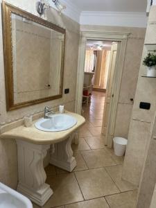 uma casa de banho com um lavatório e um espelho em Casa vacanze Conte Cavour em Laterza