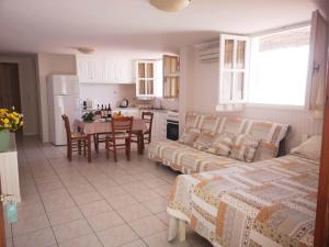 a living room with a couch and a table and a kitchen at Apartments Jasu in Kiveri