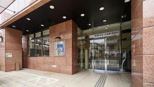 an entrance to a building with a sign on it at Toyoko Inn Osaka Tsuruhashi Ekimae in Osaka