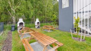 a picnic table and a bench in a yard at Zaciszna, Sun & Snow in Niechorze