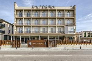 a building with a fence in front of it at Hotel Emporium - Adults Only in Castelló d'Empúries