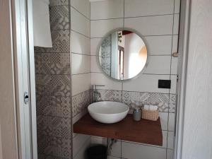 a bathroom with a sink and a mirror at Desideria Rooms Bed and Breakfast in Torino di Sangro