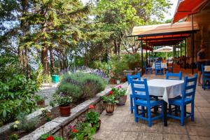 a table and chairs on a patio with plants at ADIS Holiday Inn Hotel in Golden Sands