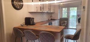 a kitchen with a wooden counter and chairs in it at Dream Apartment Timisoara in Timişoara