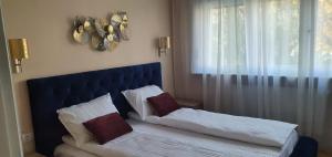 a bed with two pillows on it in a bedroom at Dream Apartment Timisoara in Timişoara +8 photos