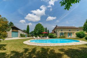 a swimming pool in the yard of a house at La Maison de Beaugas - Avec piscine dans le pays des bastides in Beaugas