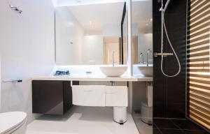 a bathroom with two sinks and a shower at Unique Rooms in Zadar