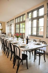 a large dining room with a long table and chairs at Transylvania Guesthouses in Cincşor