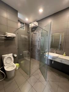 a bathroom with a shower and a toilet and a sink at Nancy Tran Grand Strip Vung Tau Villa 10 in Vung Tau