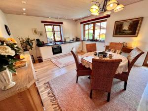 a kitchen and dining room with a table and chairs at Haus Sonnenau in Pfronten