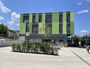 a building with a bunch of chairs in front of it at Hotel-am-Bahnhof Stuttgart-Ditzingen in Ditzingen