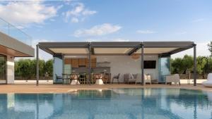 a pavilion with a swimming pool next to a house at Aesthea 5-star Villa, 2Pools, Gym, Cinema, Sauna, By ThinkVilla in Prínos