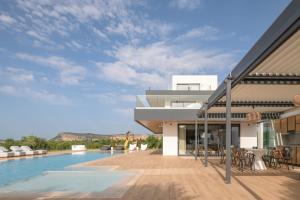 a view of a house with a swimming pool at Aesthea 5-star Villa, 2Pools, Gym, Cinema, Sauna, By ThinkVilla in Prínos