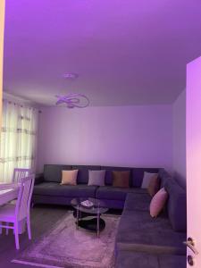 a living room with a couch and a purple ceiling at Ilia’s Guesthouse in Pogradec