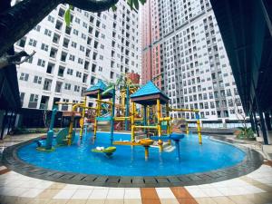 a playground in the middle of a city with tall buildings at Transpark Juanda by 21 Room in Bekasi