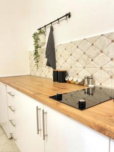 a kitchen with white cabinets and a counter top at MAKEDONKA Apartments in Ohrid