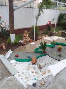 a childs play area with toys in a garden at Gradina 5 elemente in Eforie Nord