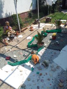 a garden with broken items on the ground at Gradina 5 elemente in Eforie Nord
