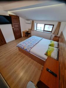 a bedroom with a large bed in a boat at Apartment Cozia in Timişoara