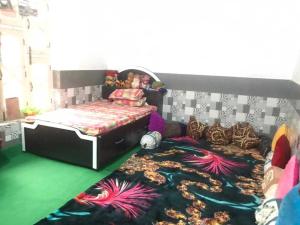 a bedroom with a bed with an octopus carpet at POP Ain Ul Noor Homestay in Thanna Mandi