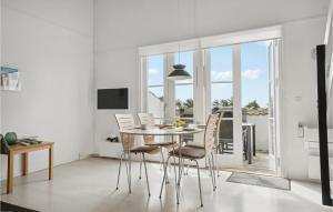 a white dining room with a table and chairs at Stunning Home In Vestervig With Sauna in Vestervig