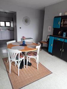 a kitchen with a table and chairs in a room at Gîte du Kreizker in Cléden-Poher