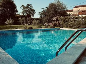 a large swimming pool with blue water at Rustic village in Rijeka Crnojevića +60 photos