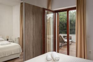 a bedroom with a bed and a view of a balcony at Apartments Hablando in Pridraga