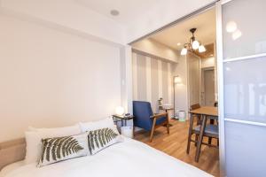 a bedroom with a bed and a desk in a room at H2H Tsutenkaku in Osaka