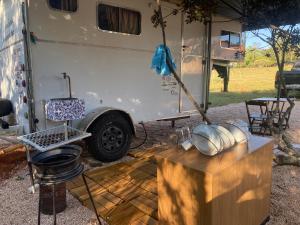 a white camper with a table at Salamandra trailerhome in Pirenópolis