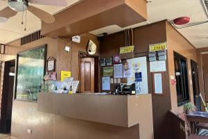 a restaurant with a counter with signs on the wall at Tenzai Homestay in Puerto Princesa City