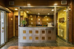 a large kitchen with a counter in a building at Hotel Emporium - Adults Only in Castelló d'Empúries