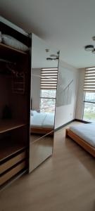 a mirror in a bedroom with two beds and a window at Tips For istanbul in Istanbul