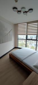 a bedroom with a large bed and a large window at Tips For istanbul in Istanbul