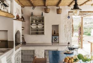 a kitchen with a counter with a blue counter top at Rizes Mykonos - Folklore Farmstead in Mikonos