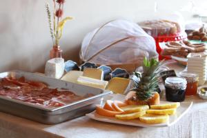 una mesa con una bandeja de carnes y otros alimentos en Bed & Brekfast da Kate Dreams and Colors, en Foglizzo