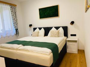 - une chambre avec un grand lit et une couverture verte dans l'établissement Ferienhaus Lemsitz 34, 