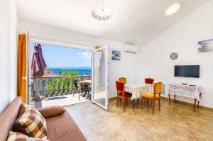 a living room with a table and a view of the ocean at Apartment in Crikvenica with One-Bedroom 3 in Crikvenica