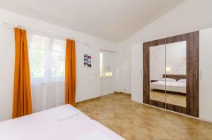 a bedroom with a bed and a large mirror at Apartment in Crikvenica with One-Bedroom 3 in Crikvenica