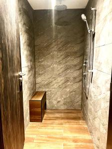 a bathroom with a shower with a wooden floor at Arena eSports @ Orchard in Singapore