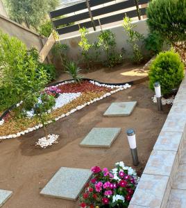 a garden with a bench and some flowers at LuMar Holidays and Apartments in Preko