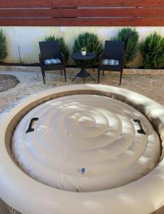 a circular pool with two chairs and a table at LuMar Holidays and Apartments in Preko
