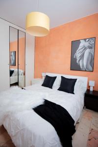 een slaapkamer met een groot wit bed en een zwarte deken bij Casa Vacanza di Monica in Bordighera