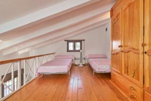 two beds in a room with a staircase at La Casita de mama in Vélez-Málaga +30 photos