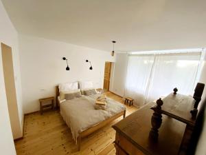 a bedroom with a bed and a table in it at Maciejowiec Castle Hill Apartment I in Maciejowiec